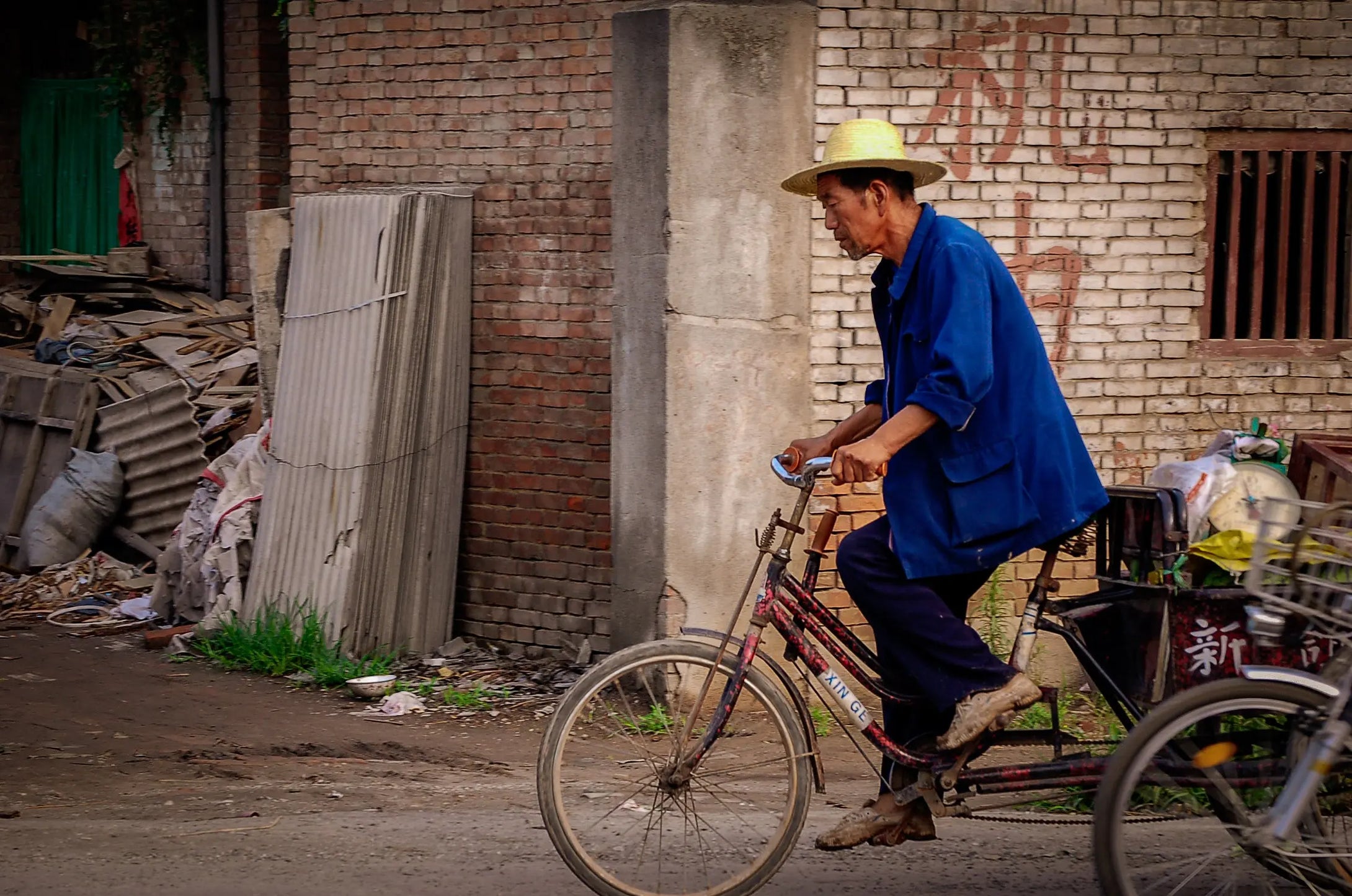 Journey Through Poverty: Solitary Cyclist in a Chinese Neighborhood Tracy McCrackin Photography - Tracy McCrackin Photography