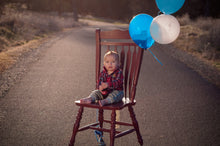 Load image into Gallery viewer, Birthday boy on a red chair Tracy McCrackin Photography - Tracy McCrackin Photography